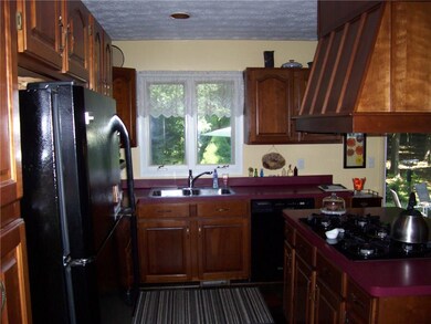 Plenty of cherry cabinetry in this spacious kitche