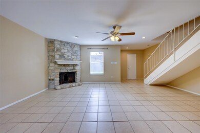 Unfurnished living room with a ceiling fan, stair
