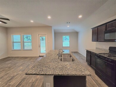 Modern open-concept kitchen, living, and dining ar
