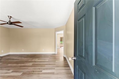 Entryway featuring light wood-style floors and a ceiling fan