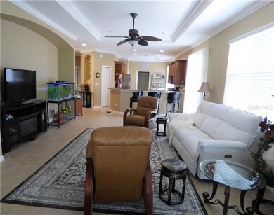 Open floor-plan with crown molding & tray ceiling