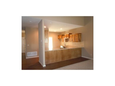 Kitchen with hardwood floors and breakfast bar.