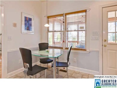 The eat-in kitchen overlooks the screened porch an