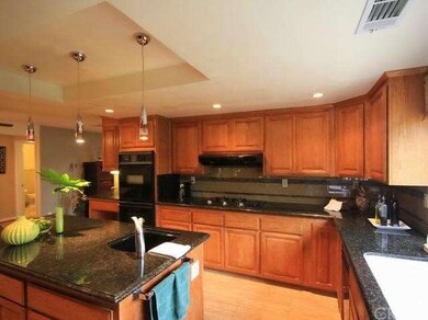 Gourmet kitchen looks out to beautiful backyard th