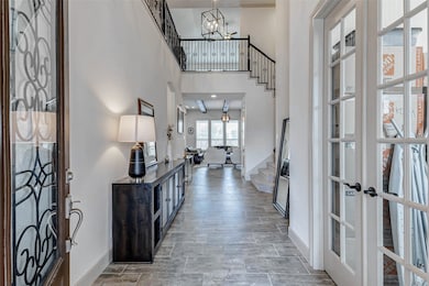 Soaring entry with Leaded glass wrought iron front