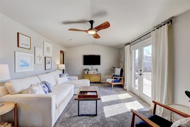Living room with vaulted ceiling, ceiling fan, car