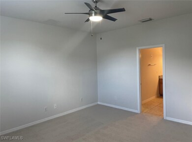 Unfurnished bedroom featuring ceiling fan and light carpet