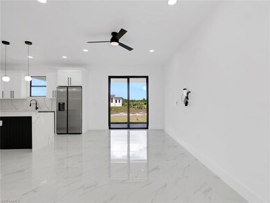 Unfurnished living room featuring light marble finish flooring, healthy amount of natural light, recessed lighting, and a ceiling fan