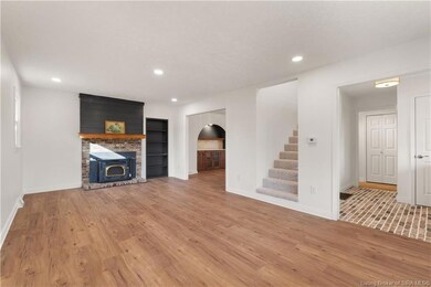 Living room w/ wood burning fireplace