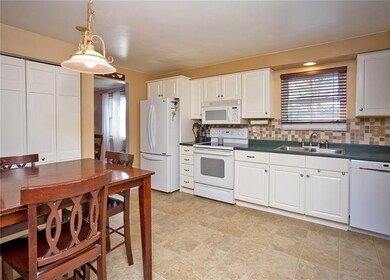 The eat-in kitchen offers plenty of storage with t