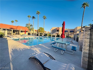 Community pool with a patio