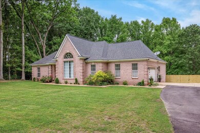 View of front of property with brick siding, a gar