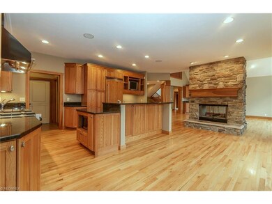Gourmet eat-in kitchen features a two-tiered cente
