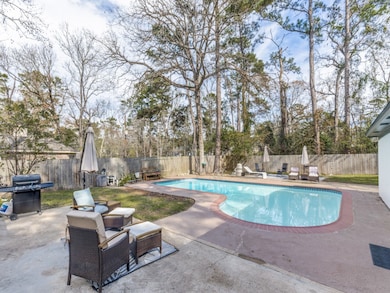 This backyard features a spacious pool surrounded