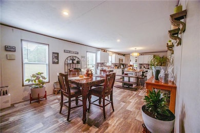 Dining room with light wood-style floors, recessed lighting, and crown molding