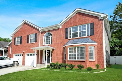 View of front facade featuring driveway, a garage,