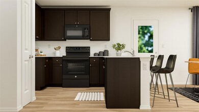 Kitchen featuring electric range, light wood-type 