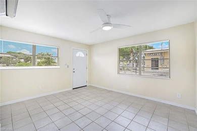 Foyer with healthy amount of natural light, ceiling fan, and light tile patterned flooring