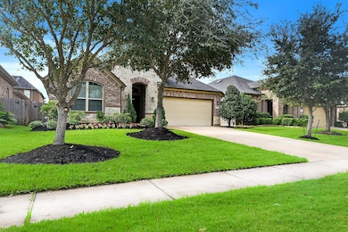 The home features professionally manicured trees and landscaping, and it comes with a full sprinkler system for easy maintenance.