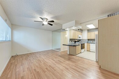 Kitchen featuring white appliances, open floor pl