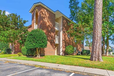 View of home's exterior with a yard and a balcony