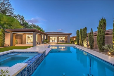 View of pool with a patio area and a pool with con