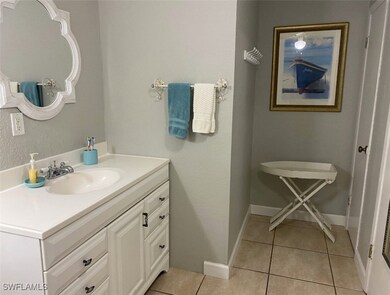 Bathroom featuring tile patterned floors, baseboar
