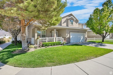 Traditional-style home featuring stucco siding, a porch, concrete driveway, a garage, and brick siding