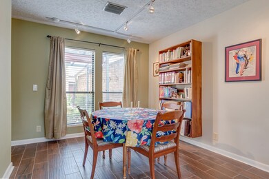 Dining area with large windows overlooks the courtyard. 