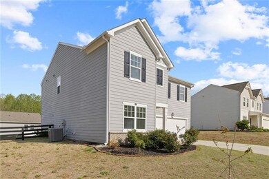 View of side of property with a garage and driveway
