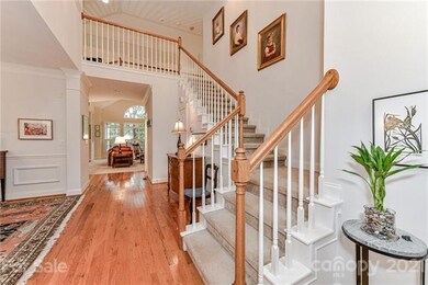 Stair case in the foyer featuring the very open fl