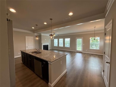 Kitchen with stainless steel dishwasher, a sink, a