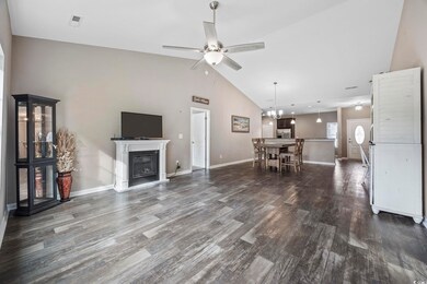 Living room featuring ceiling fan with notable cha