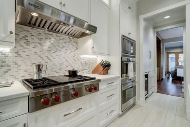 Beautiful back splash - commercial vent hood - view to butlers pantry - into dining
