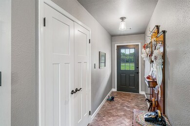 Entry with brick floor and coat closet