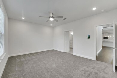 Carpeted spare room featuring ceiling fan