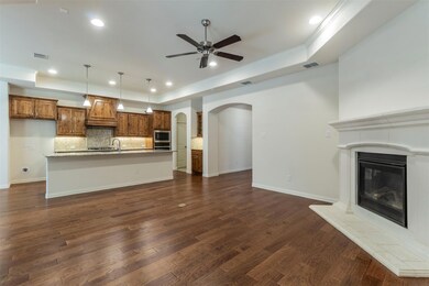 Open living room with gas log fireplace and beauti