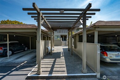 The entry and mailbox plaza. The home has two assigned parking spaces. One is in a carport and the other is an uncovered space.
