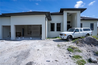Rear view of property featuring stucco siding and