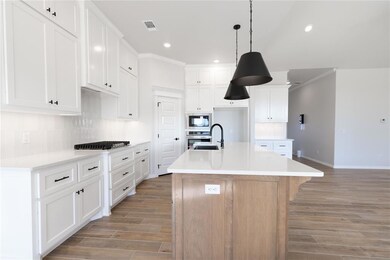 Kitchen featuring white cabinets, oven, a kitchen 