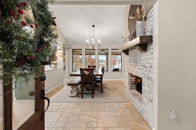 Dining area with vaulted ceiling, a brick fireplac