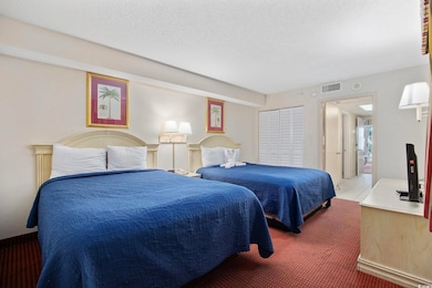 Carpeted bedroom featuring visible vents and a tex