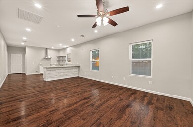 Bright and airy living space seamlessly connected to the modern kitchen.