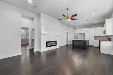 Unfurnished living room featuring a high end fireplace, ceiling fan, dark hardwood / wood-style floors, and sink