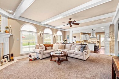 Open to the kitchen and overlooking the pool area,