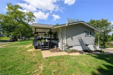 Rear view of house featuring a lawn