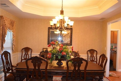 Dining space featuring visible vents, wallpapered 