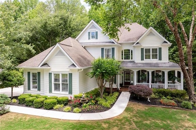 View of front facade featuring a porch, a standing seam roof, a front lawn, a shingled roof, and metal roof