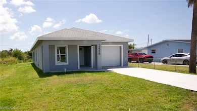 View of front of house featuring stucco siding, a shingled roof, a garage, and a front lawn