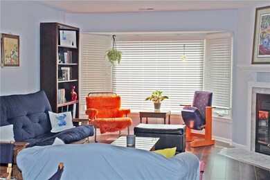 Living room with bay window and fireplace